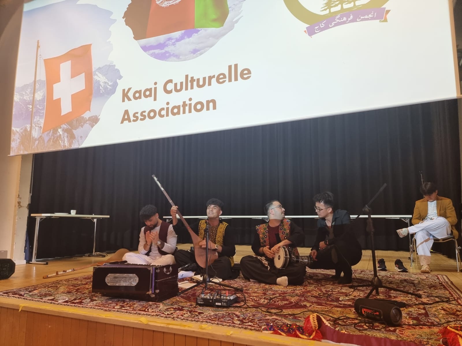 Golden mountain peaks at sunrise with scattered trees.