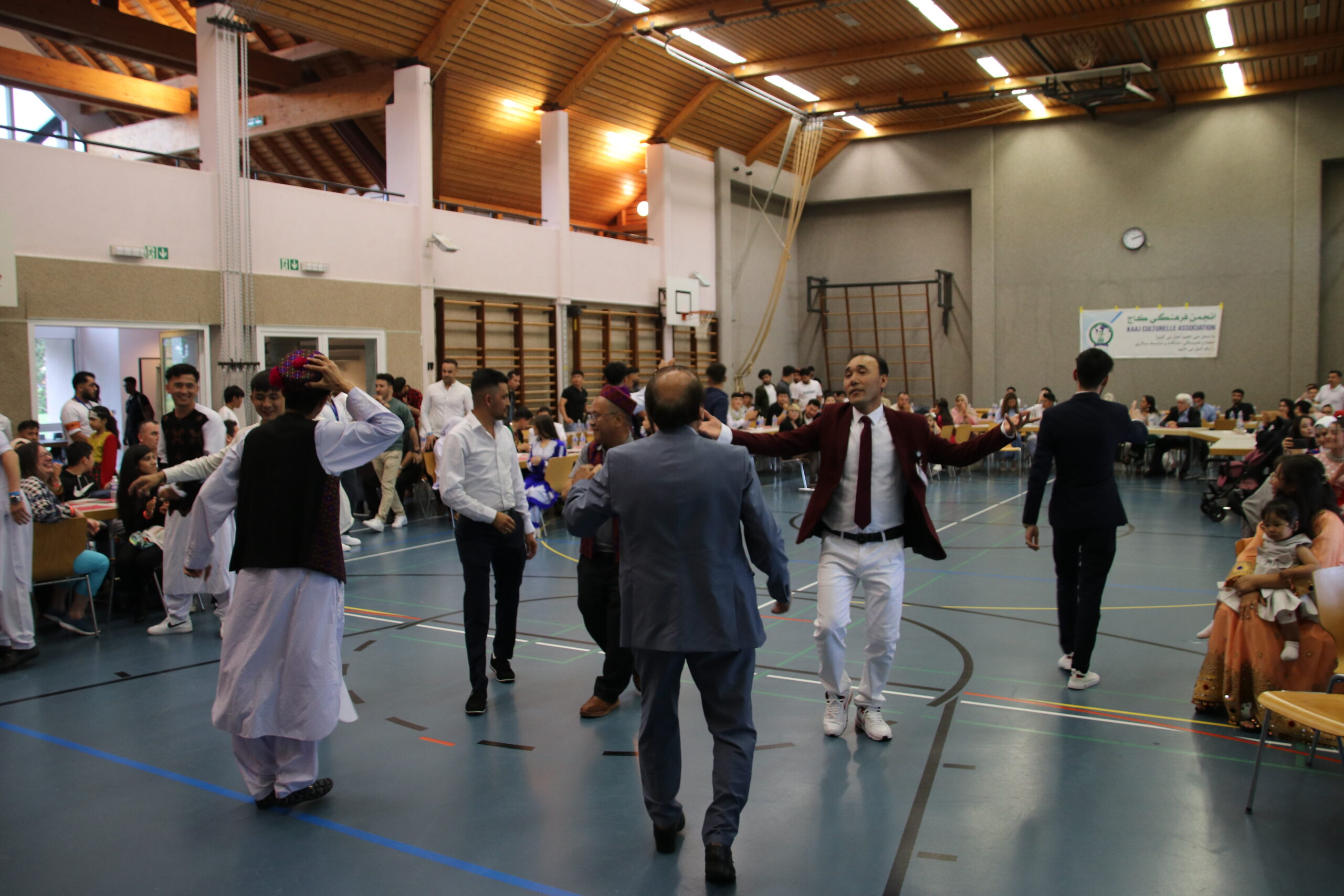 Golden mountain peaks at sunrise with scattered trees.