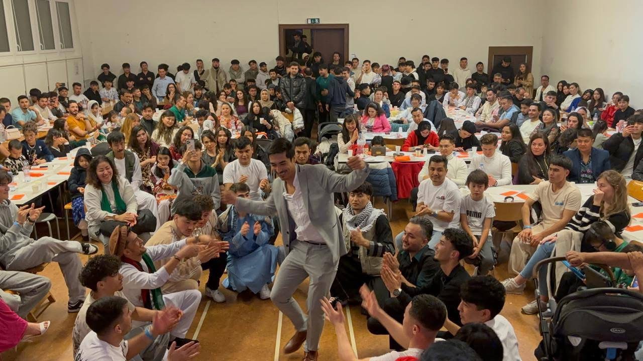 Golden mountain peaks at sunrise with scattered trees.