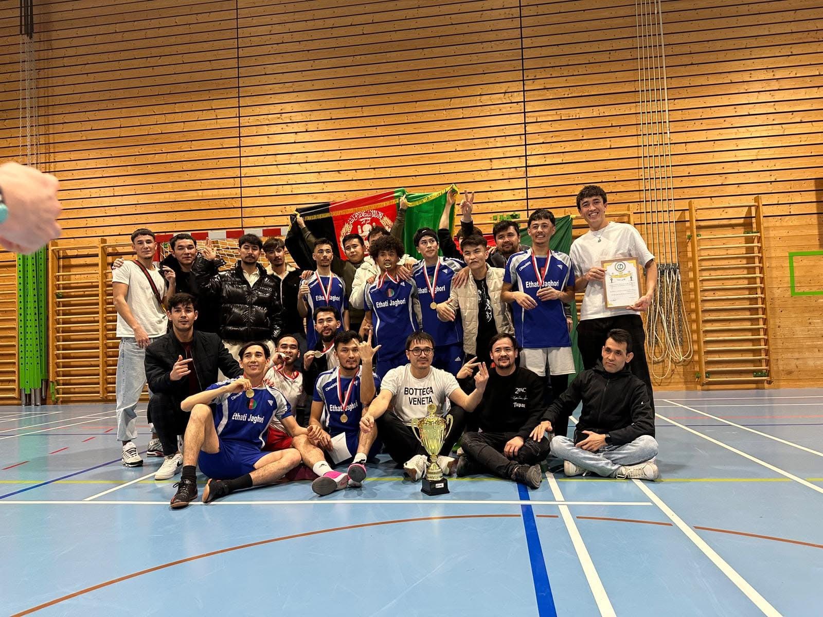 Golden mountain peaks at sunrise with scattered trees.